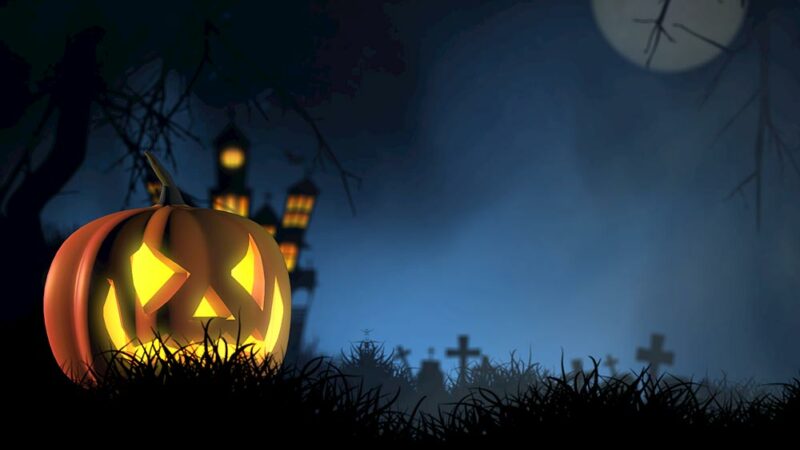 Spooky Halloween scene with pumpkin and cemetery 
