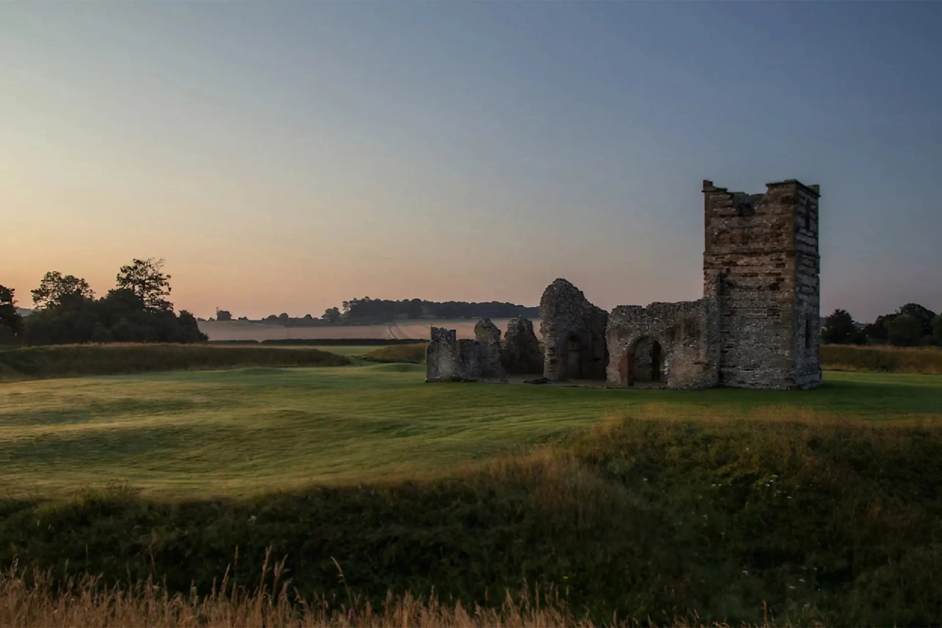 Knowlton Church, Dorset with mist on the fields as the sun comes up 9044: UNESCO Heritage countryside. Credit: National Trust