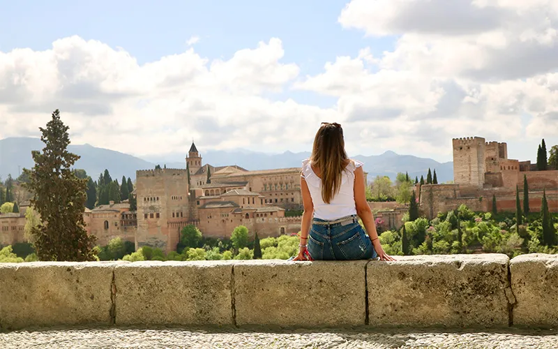 Woman enjoying the view of the Alhambra of Granada