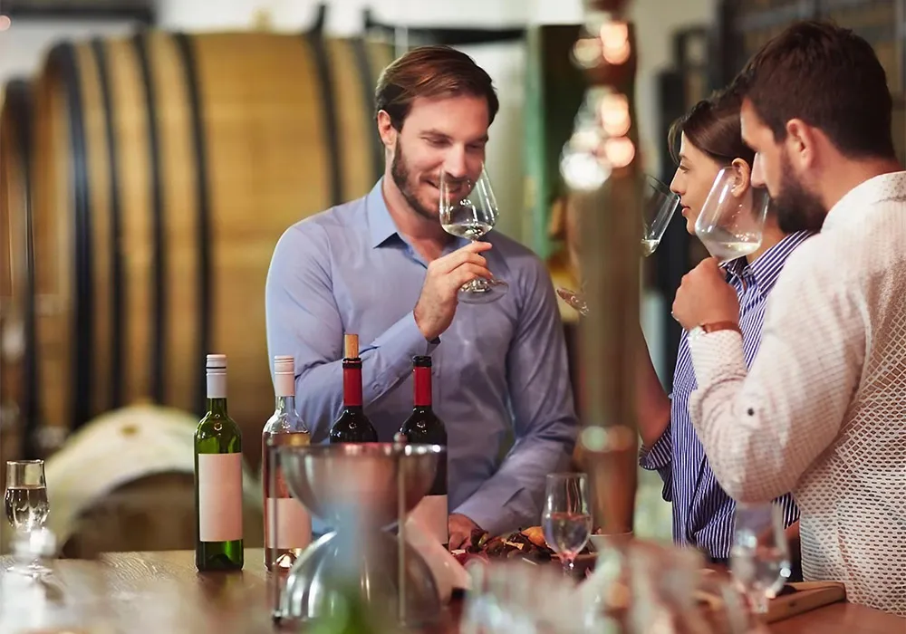 Autumn Wine and Tastings in Andalucía 4 Three people at a wine tasting in a bodega. Credit: Canva